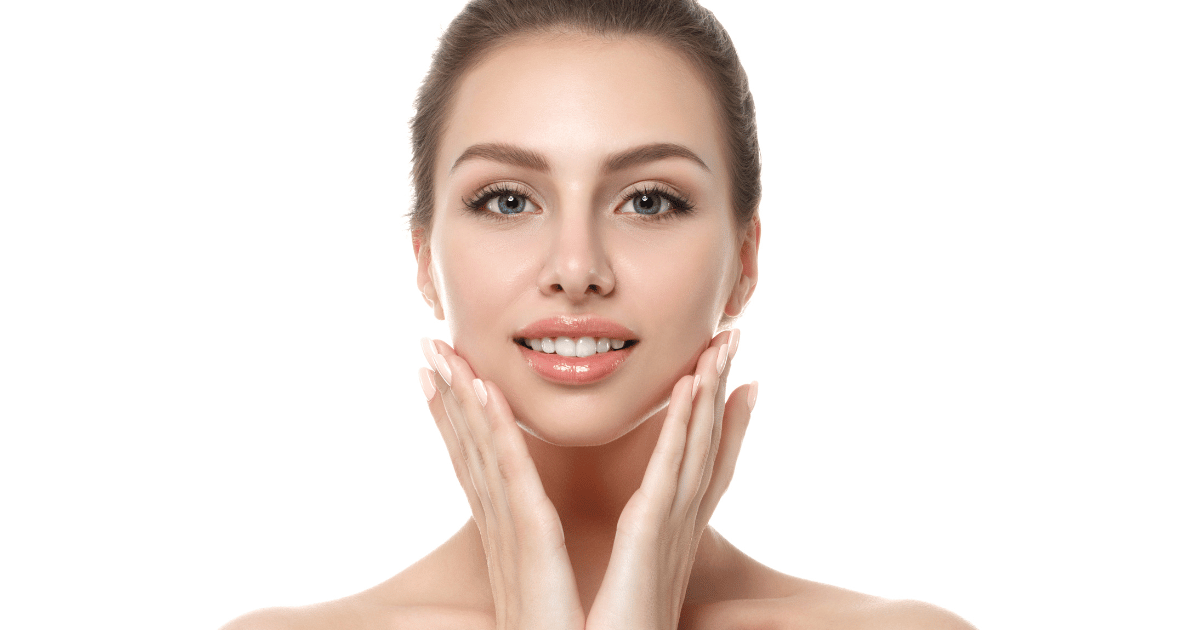 a woman smiling while holding her lovely face