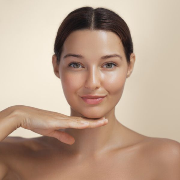 A pretty woman with glowing skin highlights the rejuvenating benefits of Cool Jet treatment at Admire Aesthetics in Medford and Grants Pass, OR.