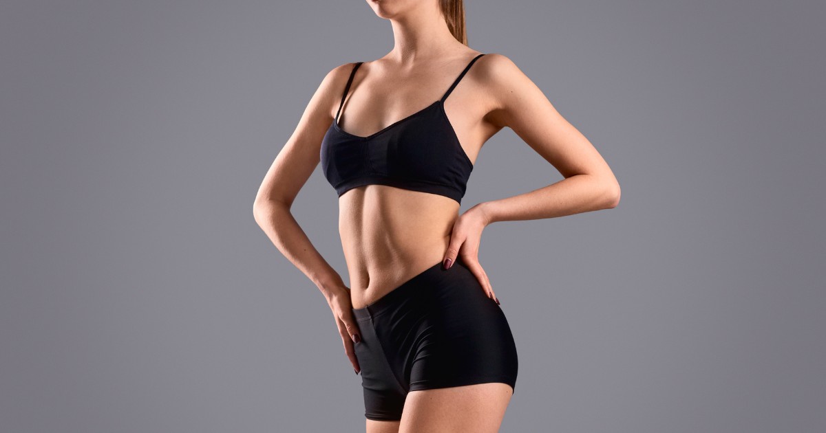 a woman with a perfect body wearing a black suit