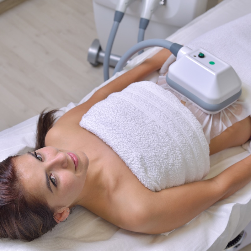 a woman getting emsculpt neo on the stomach