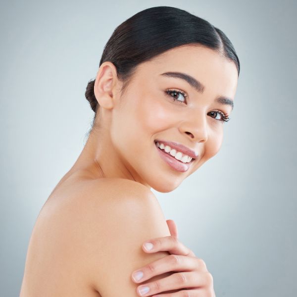 A beautiful woman with flawless skin promoting Bio Re Peel 13 for acne and acne scar treatment at Admire Aesthetics in Medford, OR