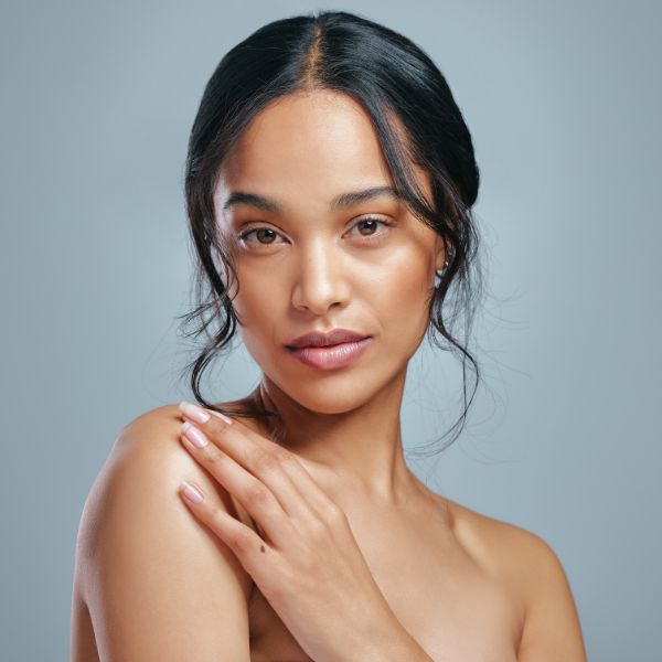 A radiant woman with youthful skin promoting Exosome therapy at Admire Aesthetics in Medford, OR