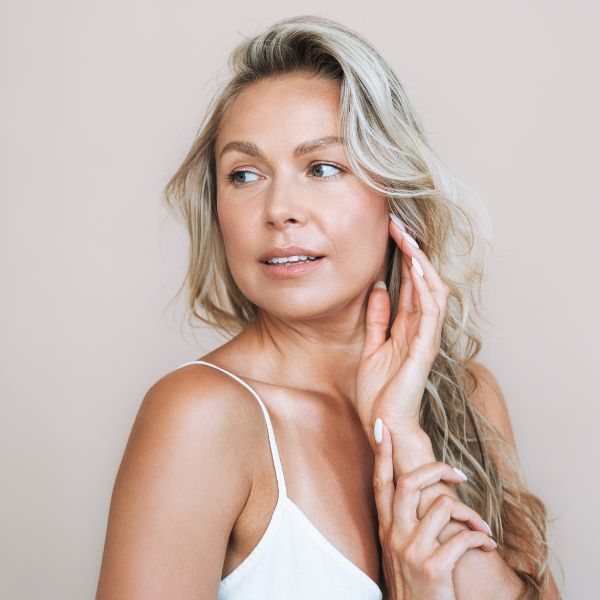 Beautiful woman with rejuvenated skin promoting Microneedling treatment at Admire Aesthetics in Medford, OR