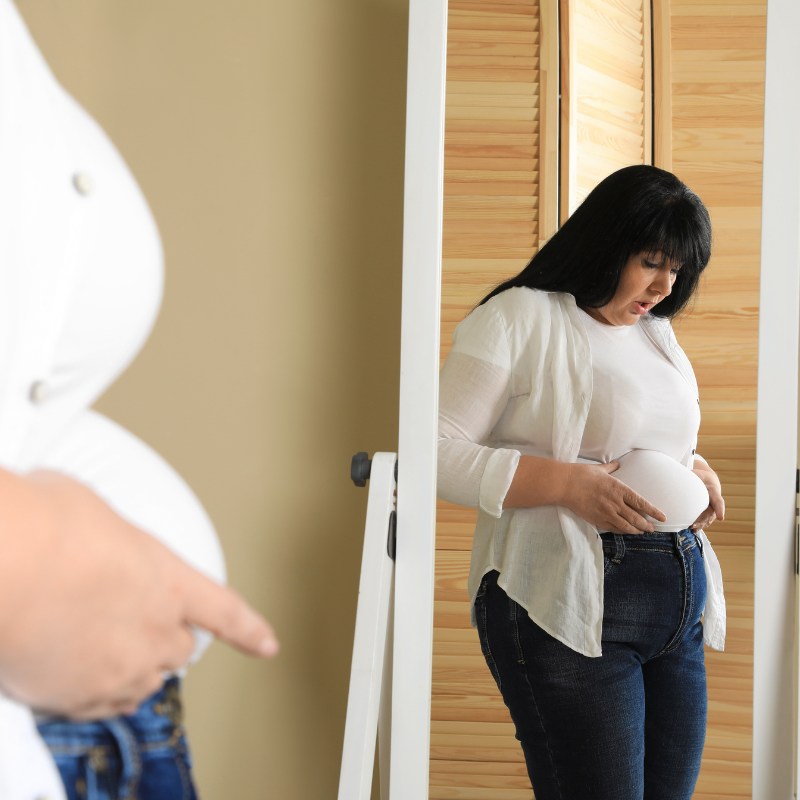 woman looking at her belly