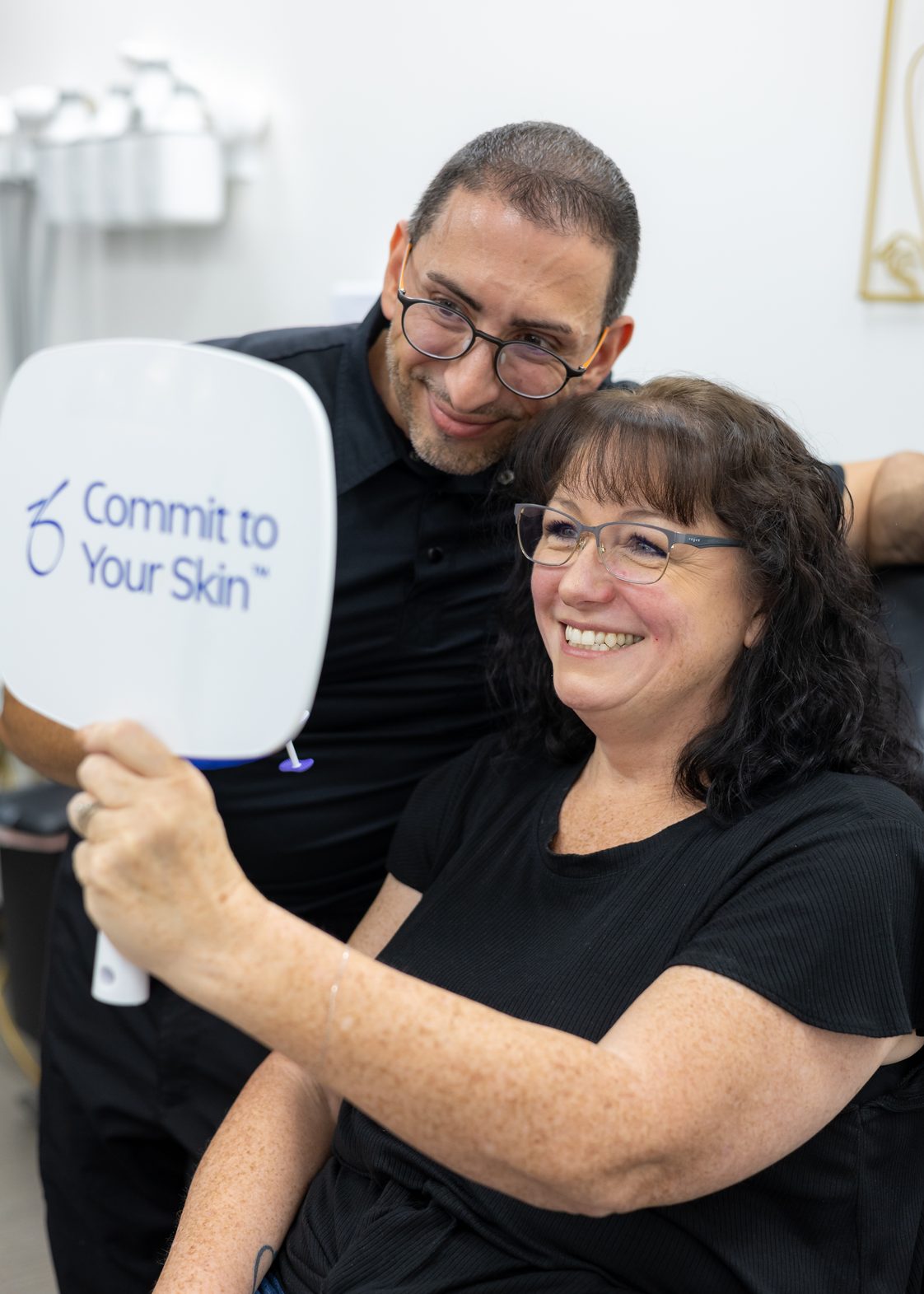 Annual Beauty and Wellness Event Admire Aesthetics talks-2 Admire provider and smiling patient viewing her results in a hand mirror